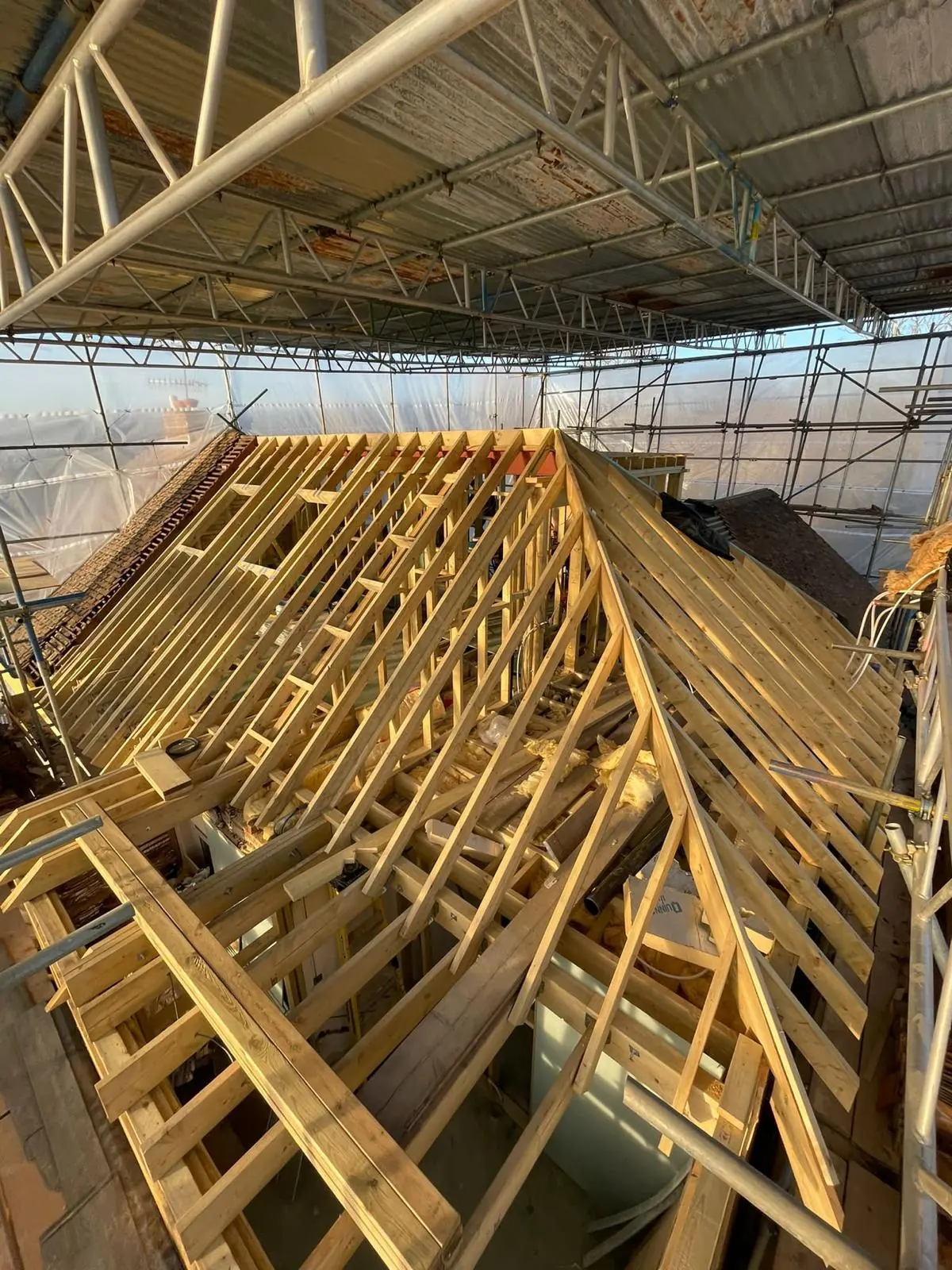 Timber roof structure beneath protective scaffolding